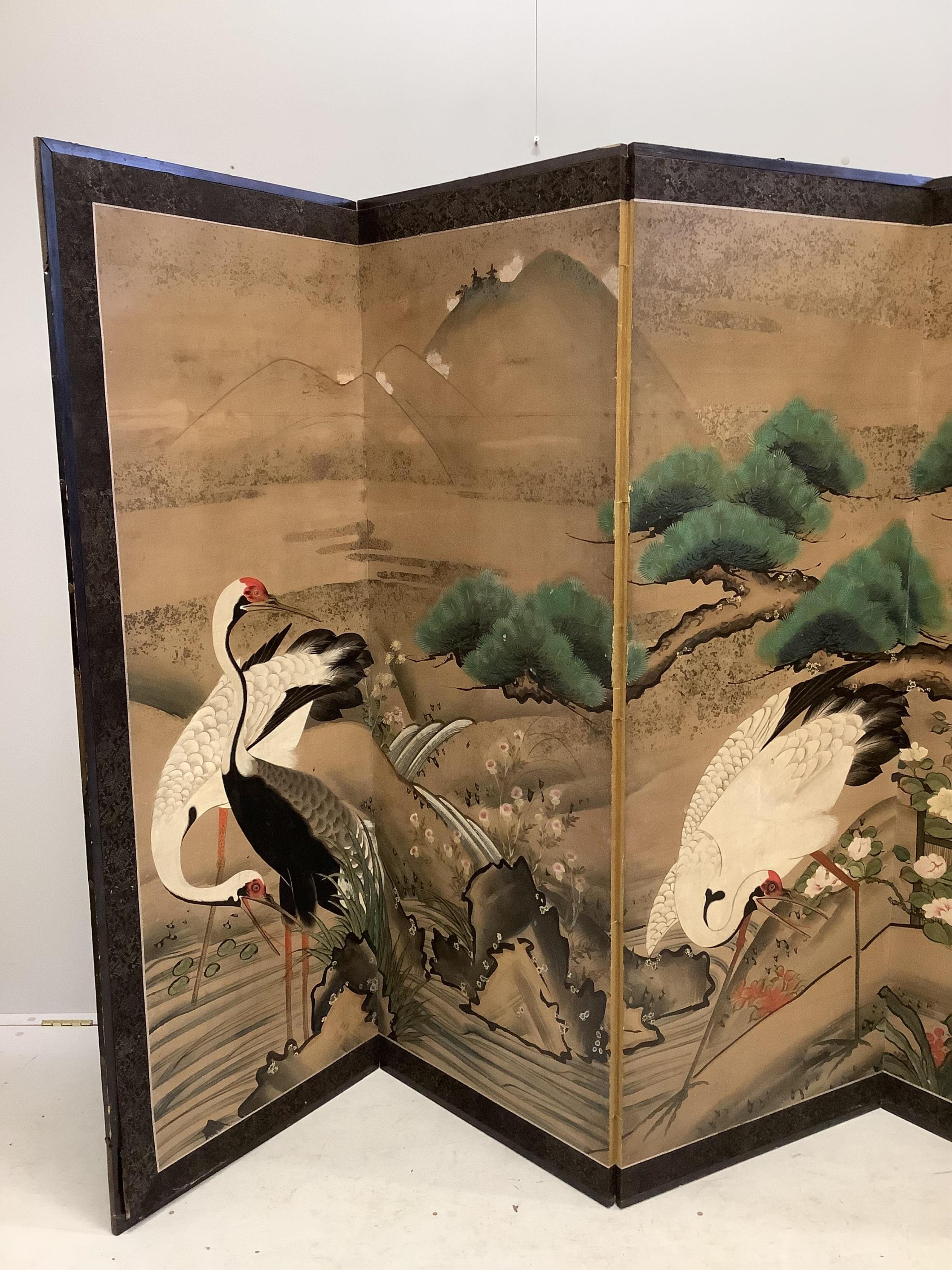 A late 19th century Japanese six section dressing screen, paper laid on frame, decorated with storks in landscape, each panel width 61cm, height 166cm. Condition - fair